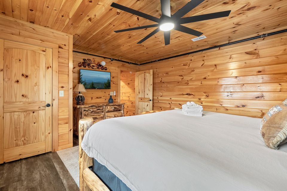King bedroom with wall-mounted TV