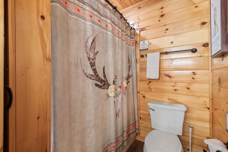Bathroom with antler shower curtain
